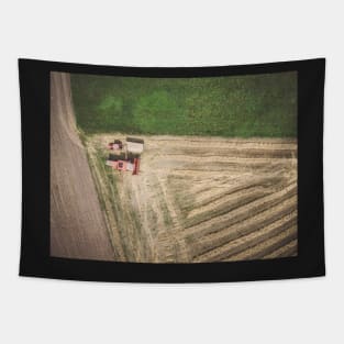 Aerial view of combine-harvester and tractor working in the field Tapestry