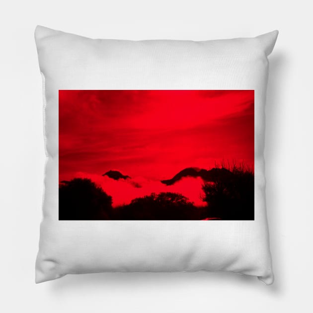 New Zealand tiered scene of high country mountains and bush shrouded by low cloud with wind-blow cloud above in red and black effect. Pillow by brians101