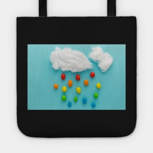 Photo illustration depicting clouds and rainbow-colored raindrops Tote