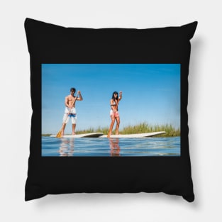 Man and woman stand up paddleboarding Pillow