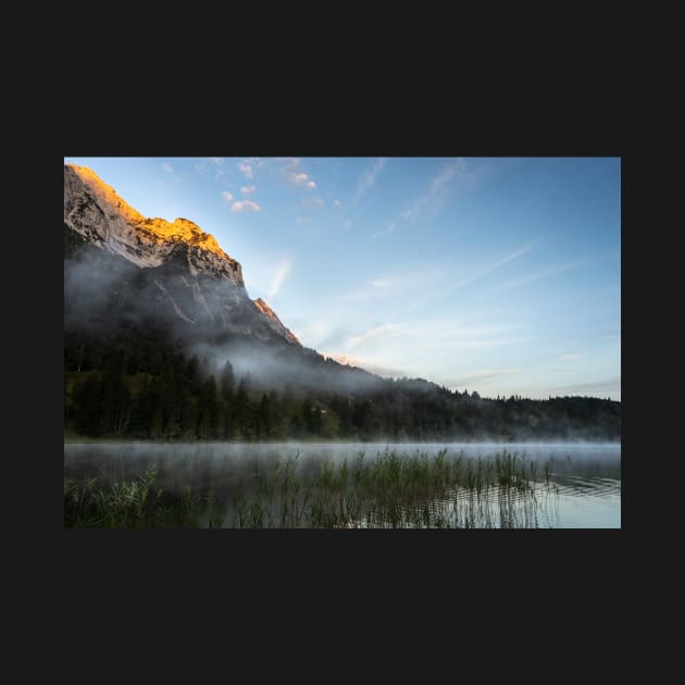 Mist on Alp mountain at Ferchensee. Amazing shot of the Ferchensee lake in Bavaria, Germany, in front of a mountain. Scenic foggy morning scenery at sunrise. by EviRadauscher