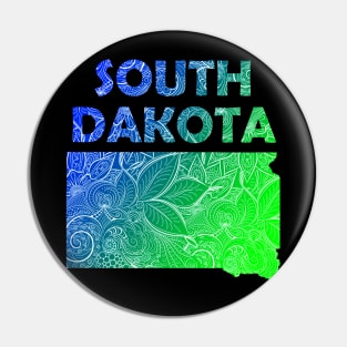 Colorful mandala art map of South Dakota with text in blue and green Pin