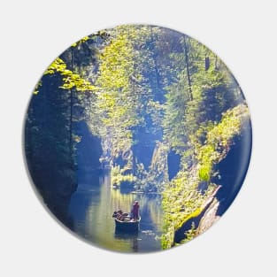 Man in the boat floating on river Pin