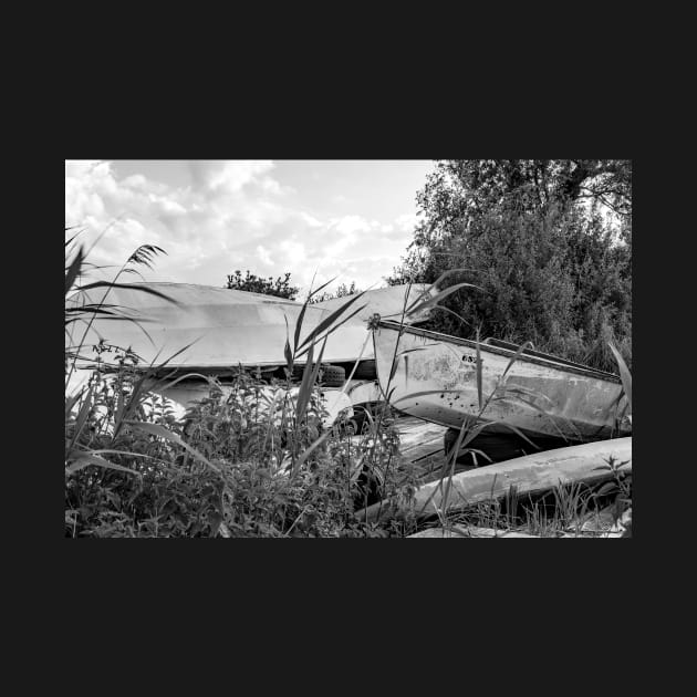 Old canoes and kayaks on the river bank in Thurne, Norfolk by yackers1