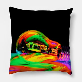 Illuminated light bulb reflecting colors against black background Pillow