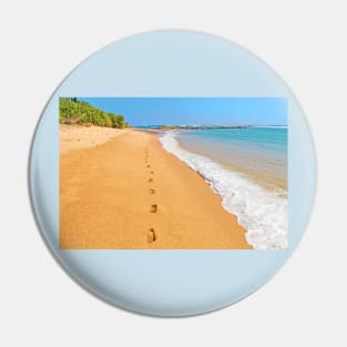 Footprints on sunny beach by emerald sea Pin