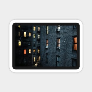 Illuminated windows in New York City courtyard at twilight Magnet