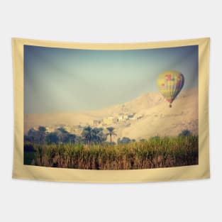 hot air balloon over a traditional village in the Egyptian countryside Tapestry