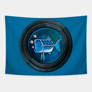 A Sleepy Blue Fish framed by a Porthole Tapestry