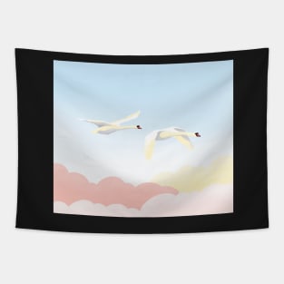 Graceful white swans flying in the blue sky Tapestry