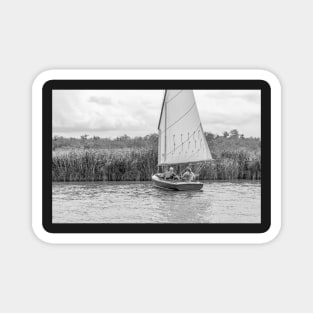 A couple sailing in the Norfolk Broads national park Magnet