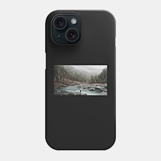 A man standing on jagged rocks in a fast-flowing river in the wilderness Phone Case