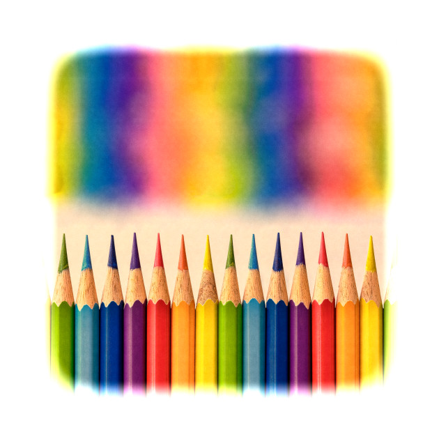 Retro style image of colorful coloring pencils with an out of focus vibrant rainbow  mural graphic above the row. by Earthworx