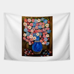 A lovely boutique of flowers in different shade of pink and purple and white . In a beautiful blue metallic vase . Tapestry