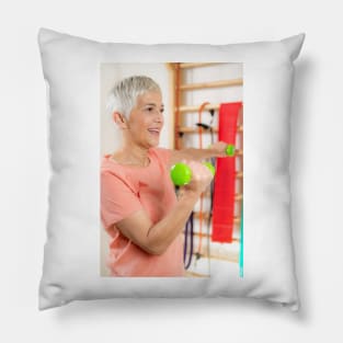 Senior woman exercising with dumbbells (F024/9971) Pillow