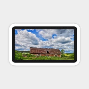 Blue cloudy sky over stork sitting on the edge of barn, Poland, Europe Magnet