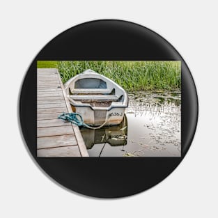 Boat tied to wooden staging on the Norfolk Broads Pin