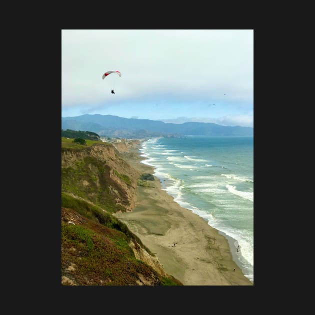 Paraglider above Pacific Ocean in California by ephotocard