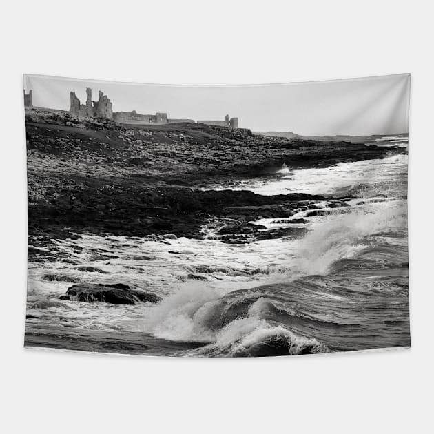 Rough waves hit the rocks near Dunstanburgh castle in Northumberland, UK Tapestry by richflintphoto