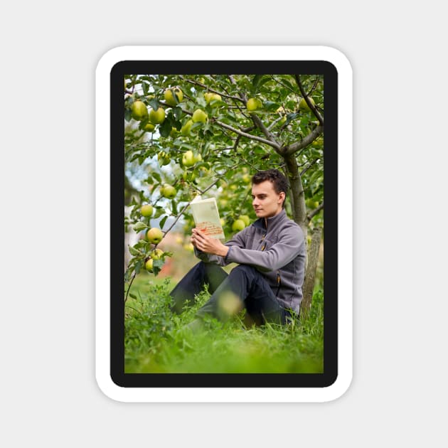 Teenager reading a book in the orchard Magnet by naturalis