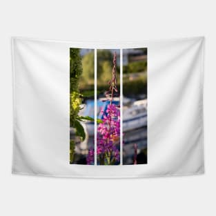 Wonderful landscapes in Norway. Blooming colorful lupine flower in Norway in the wild grass. Blur harbour background with boats. Summer sunny day (vertical) Tapestry