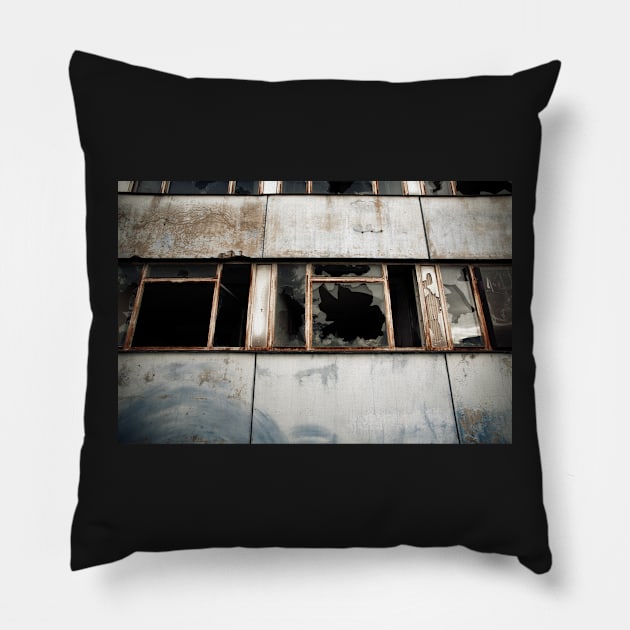 Broken windows of a derelict modern building in East Berlin. Pillow by Reinvention