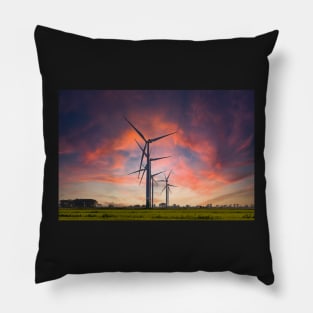 Windmill farm on green meadow under moody red sky Pillow