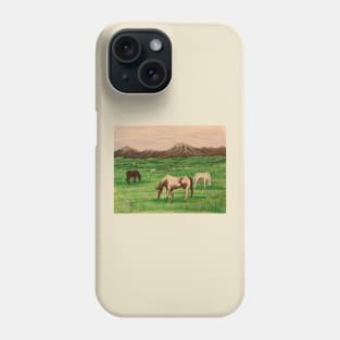 Horses grazing near the mountain range Phone Case