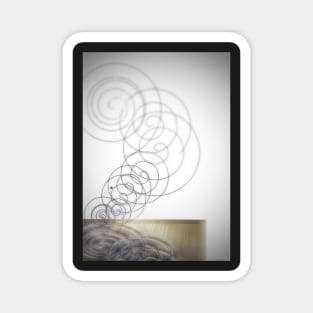 Modern spinning spiral on a wooden table Magnet