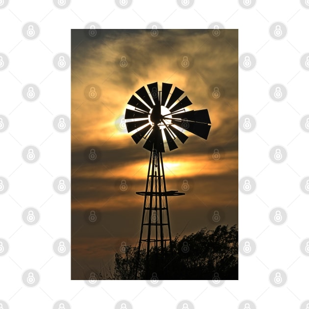 Kansas Windmill silhouette Sunset with a colorful sky. by ROBERTDBROZEK