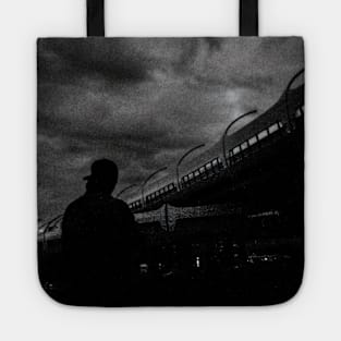 35mm black and white film photo // The man in the cap is standing near the big bridge Tote