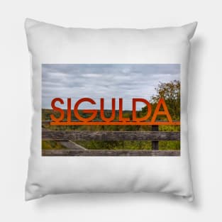 Big orange inscription Sigulda on wooden balustrade Pillow