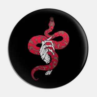 Red snake in skeleton hand Pin