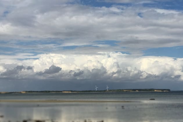 Relaxing view on Baltic seascape with thick cumulus cloud horizon and two power wind turbines in background Kids T-Shirt by Khala