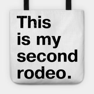 "This is my second rodeo." in plain white letters - cos you're not the noob, but barely Tote