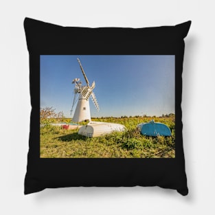 Day boats upside down on the riverbank with Thurne Mill in the background Pillow