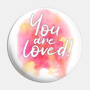 "You are loved" on pink and yellow watercolor splash Pin