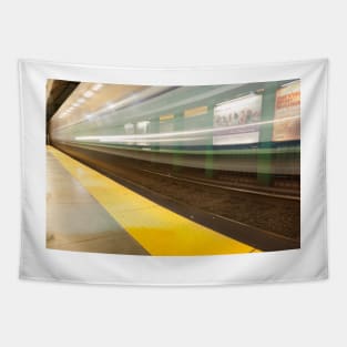 Platform with yellow line railway tracks blurred in motion blur aws train passes. Tapestry