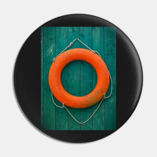 Orange Lifesaver on Green Wooden Wall Pin