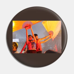 Dance performer raising arms with paper fans Pin