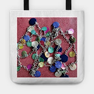 Colourful shell necklace on red leather background Tote