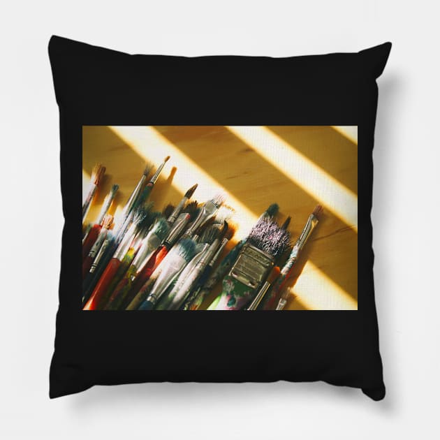 Art brushes on a wood table Pillow by bernardojbp