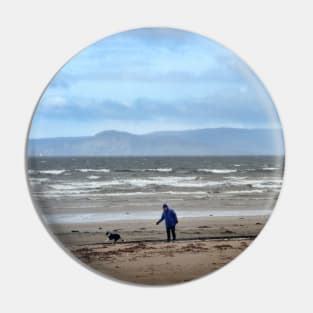 Walking the dog in blustery weather at Ardrossan, North Ayrshire, Scotland Pin