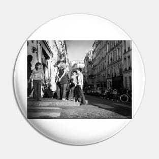 French street imagery group of young adults on Montmartre street corner outside pub Pin