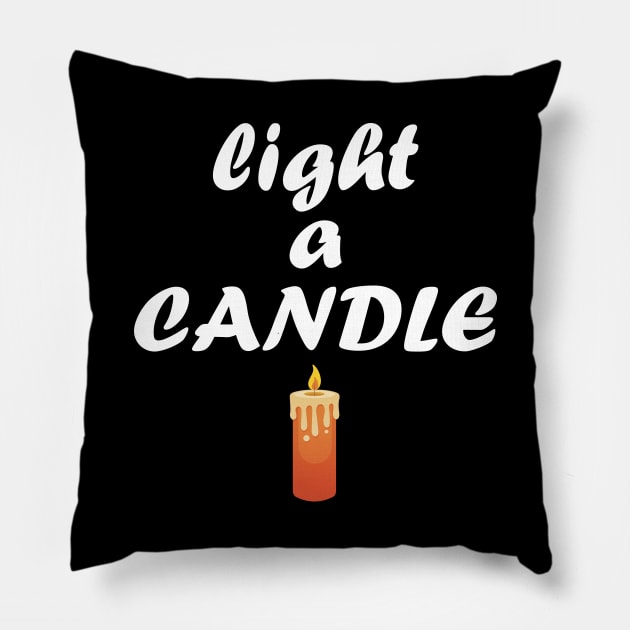 light a candle Pillow by teestaan