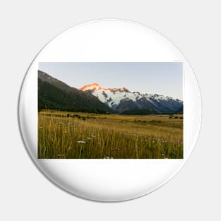 Mount Cook National Park at daybreak as rising sun strikes peaks of surrounding mountains Pin