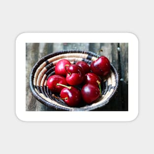 Red cherries in a basket. Magnet