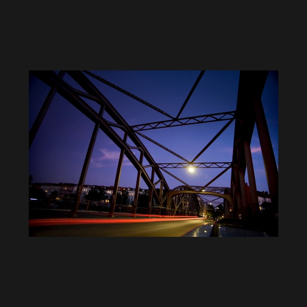 Perspective of an iron bridge with car light trails at twilight in Berlin, Germany by Reinvention