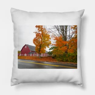 Traditional American style red barn from passing highway in fall with bright foliage in rural USA Pillow