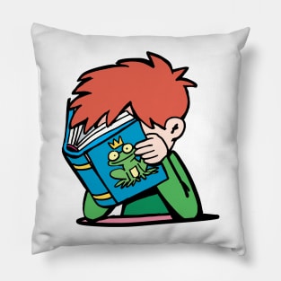 boy with his head in a book reads a fairy tale about a frog prince Pillow